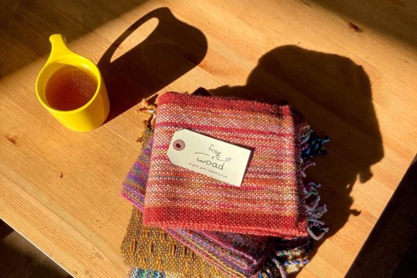 Frog & Woad hand woven scarves on a table