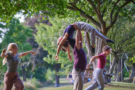 Acrobat being carried on outstretched hands
